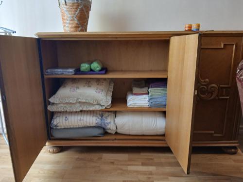 a wooden book shelf with folded towels in it at Parlament in Tallinn