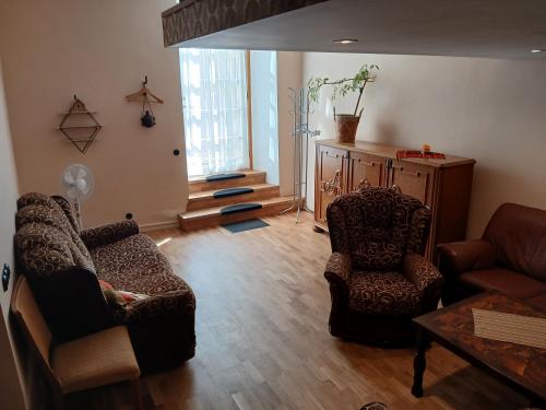 a living room with two chairs and a couch and a table at Parlament in Tallinn
