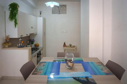 a kitchen with a table with a vase on it at MARINA ELISIR in Marina di Ragusa