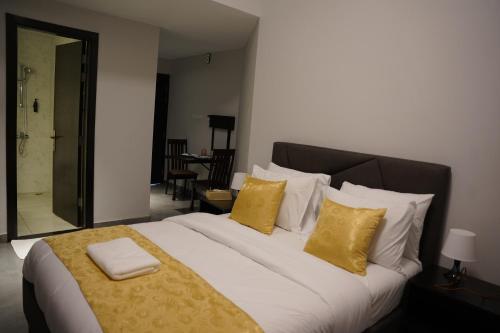 a bedroom with a large bed with yellow pillows at Ista Vacation Homes Rental LLC in Dubai