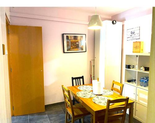 a dining room with a wooden table and chairs at 3 Bedroom Next to Airport & La Sagrada Familia Metro and FC barcelona Stadium in Hospitalet de Llobregat