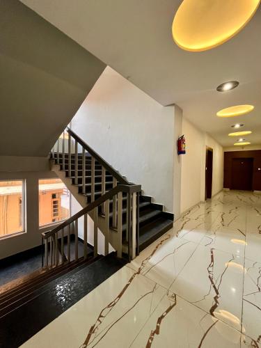 an empty lobby with a staircase in a building at Hotel Viva La Vida in Dalhousie