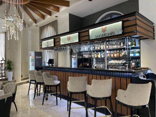 a bar with a bunch of chairs in a restaurant at Ametist Hotel Complex in Samarkand
