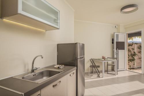 a kitchen with a sink and a refrigerator at Heaven's Door in Samos
