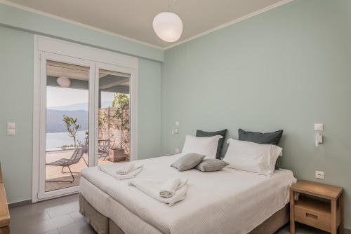 a bedroom with a bed with a view of the ocean at Heaven's Door in Samos