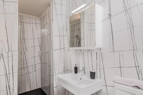a white bathroom with a sink and a mirror at Heaven's Door in Samos