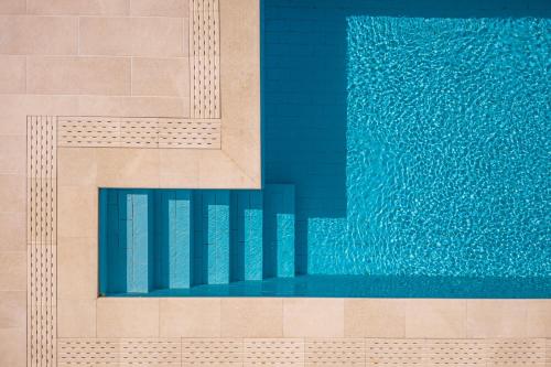 an illustration of a swimming pool with blue water at Heaven's Door in Samos
