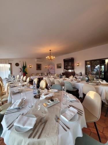 a dining room with white tables and chairs at Boutique Inn & Restaurant - Casa dos Suécos in Figueira da Foz