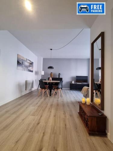 a living room with a table and a dining room at QEhome confort y parquing en el centro de Manresa in Manresa