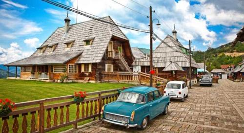 an old blue car parked in front of a house at Tara Mountain House in Bajina Bašta