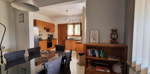 a kitchen and dining room with a table and chairs at Shanti Paphos Holiday House in Paphos City