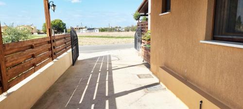 a shadow of a fence on the side of a building at Shanti Paphos Holiday House in Paphos City