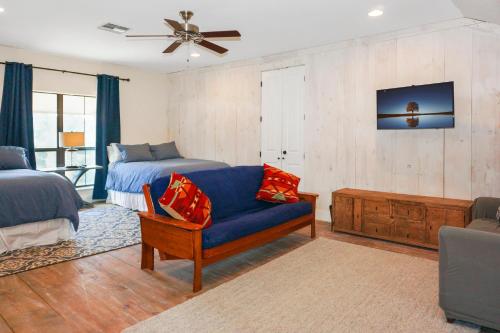 a bedroom with a blue couch and a bed at Paloma Ridge in Fourth Crossing