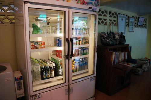 a refrigerator filled with lots of bottles of alcohol at Samsen Sam Place in Bangkok