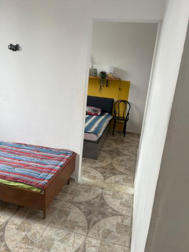 a small room with a bed and a table at Olympia Ureki Guria Street 24-26 in Ureki