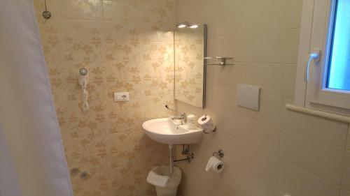 a bathroom with a sink and a mirror at Mediterranea Sea House in Montesilvano