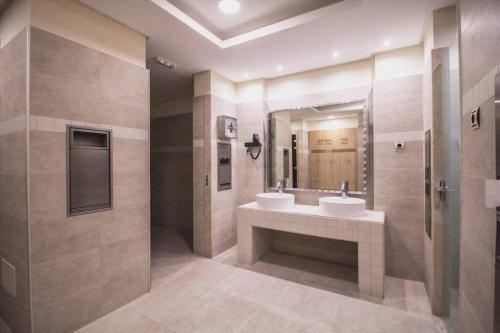 a bathroom with two sinks and a large mirror at Samara 20 Luxury Apartments Spa Gym Pools Panoramic Views in Marbella
