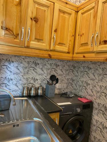 a kitchen with a sink and a washing machine at Grumpy Awa in Sere Kunda