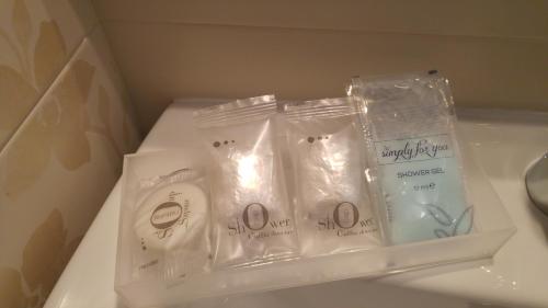 three packages of toothbrushes in plastic bags on a sink at Mediterranea Sea House in Montesilvano