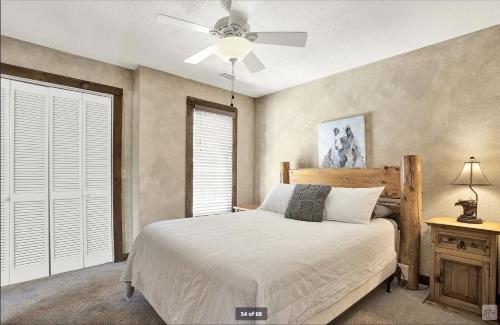 a bedroom with a bed and a ceiling fan at Birds Eye Cabin - Sunset & Starry Retreat Pet Friendly w Private HotTub, Fire Pit and Game Room in Ellijay