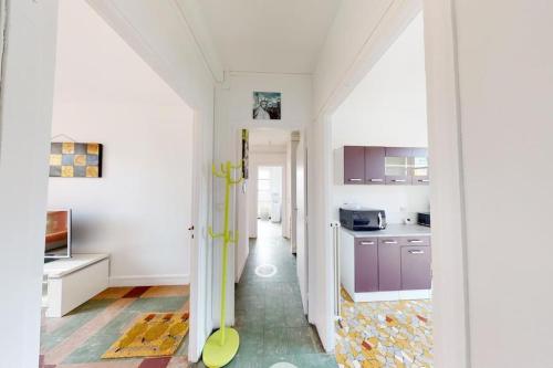 une cuisine avec des murs blancs et des armoires violettes dans l'établissement F3 - Rue Dauphine, au Havre