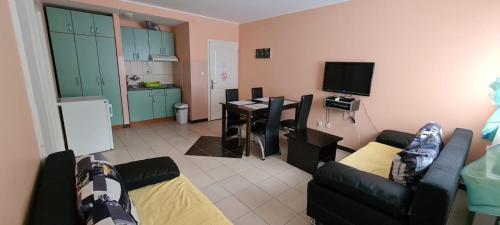 a living room with two couches and a kitchen with a desk at Vila Marina Divčibare in Divčibare