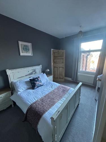 a bedroom with a white bed with a pillow on it at Comfy 3 Bedroom Home Free Parking in Doncaster in Balby