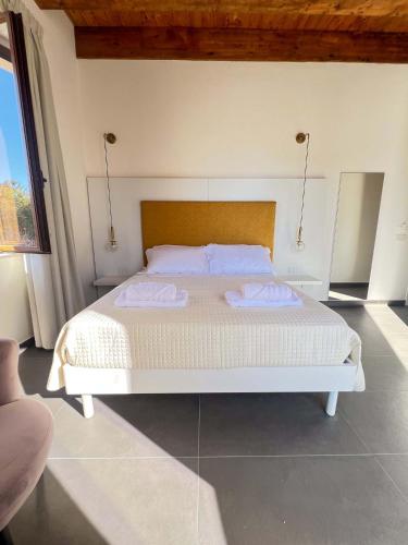 a bedroom with a white bed with two towels on it at B&B Piazza d'Armi Lamezia Terme - 3 sorrisi in Lamezia Terme
