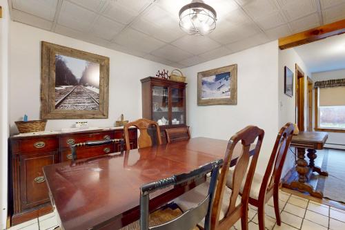 a dining room with a table and a mirror at Mount Holly Ski House in Mount Holly