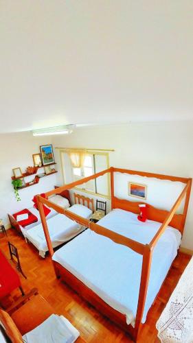 a bedroom with three beds in a room at Casa Diamantina in Diamantina