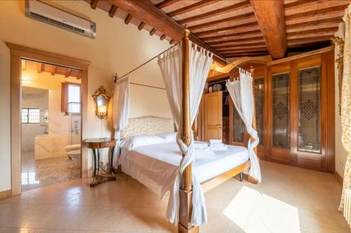 a bedroom with a canopy bed and a bathroom at Lussuoso appartamento vista Duomo in Florence