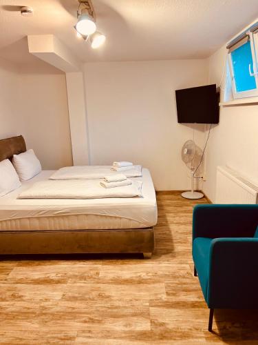 a bedroom with a bed and a tv and a couch at Gästehaus Dolce Vita in Rust