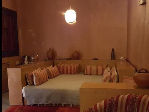 a bedroom with a large bed with pillows on it at Terres d'Amanar in Tahannout