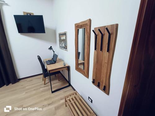 a room with a desk and a mirror on a wall at La Cerasa in Contigliano