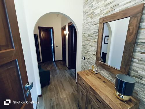a bathroom with a mirror on a stone wall at La Cerasa in Contigliano
