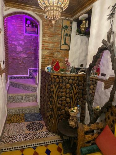 a room with a purple door and a table at Dar Nakhla in Chefchaouene