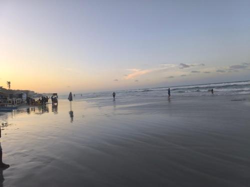 a group of people on the beach at sunset at Salinas Exclusive Resort in Salinópolis