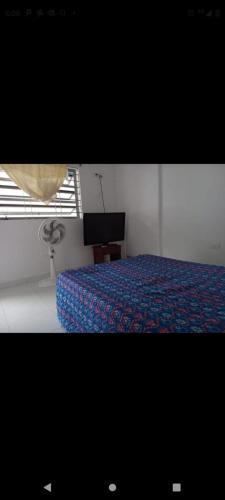 a bedroom with a bed and a television in it at Hotel la Bastilla in Sincelejo