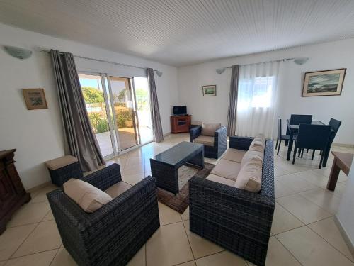 a living room with two couches and a table at Aux 2 Métis in Toliara