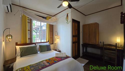 a bedroom with a large bed and a window at Greenheart Boutique Hotel in Paramaribo