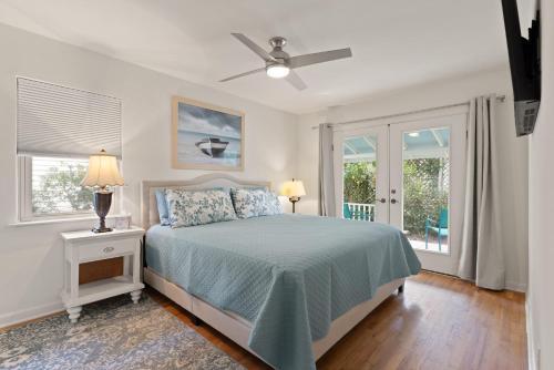 a bedroom with a bed and a ceiling fan at Sea Lyon Around - 1134 Park in East End