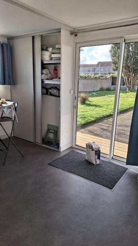 a living room with a sliding glass door to a yard at Maison studio, tiny house, petite maison, maison 23 m2 in Toul