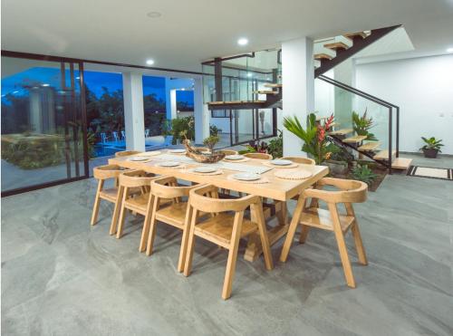 a wooden dining table and chairs in a house at Grand Cypress Luxury Home in Montenegro