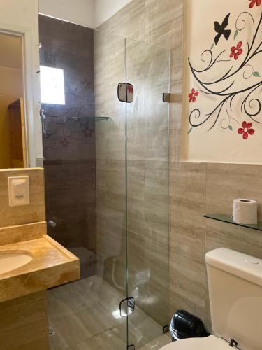 a bathroom with a shower with a toilet and a sink at Pousada Ceará - Porto das Dunas in Aquiraz