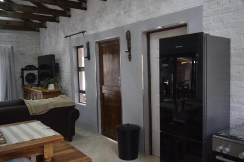 a living room with a couch and a tv at Out of Africa on Vaal in Parys