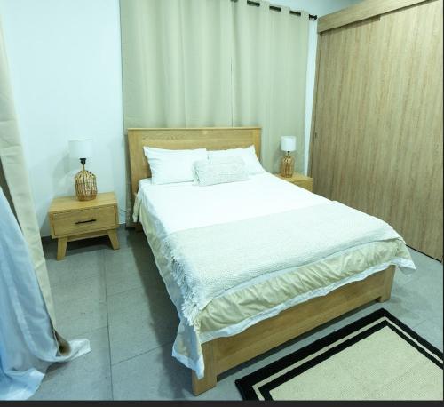 a bedroom with a large bed and two night stands at Grand Cypress Luxury Home in Montenegro