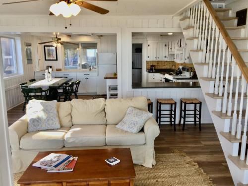 a living room with a couch and a kitchen at GRANDVIEW LAKEFRONT LIMIT 9 villa in North Sebago