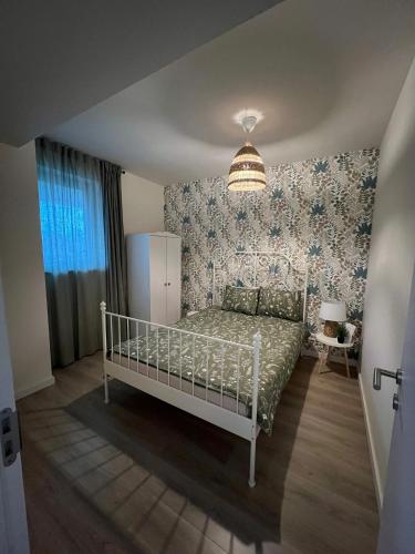 a bedroom with a white bed in a room at Victoria Condo Otopeni- Self Check-in and Check- out in Otopeni