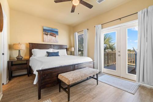 a bedroom with a bed and a sliding glass door at Molokai Villas Riverside 7A in Perdido Key