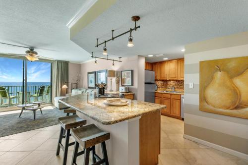a kitchen with a large island with bar stools at Perdido Towers West 907 in Perdido Key